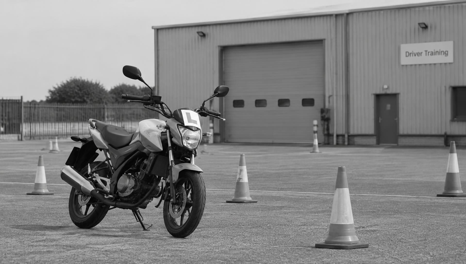 Learner motorcycle on a training area with cones