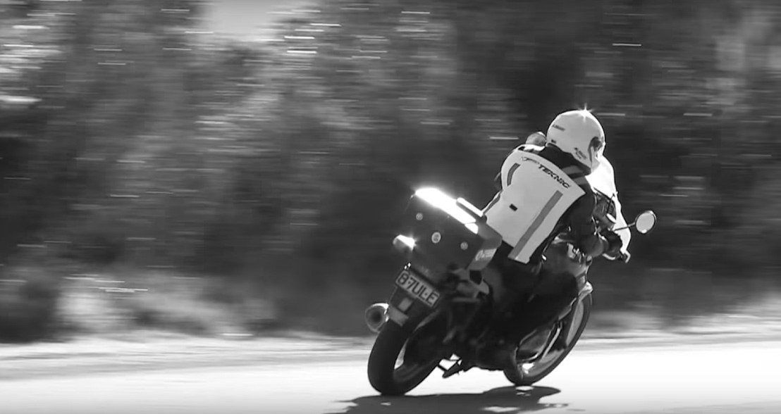 Motorcycle rider leaning into a corner at speed